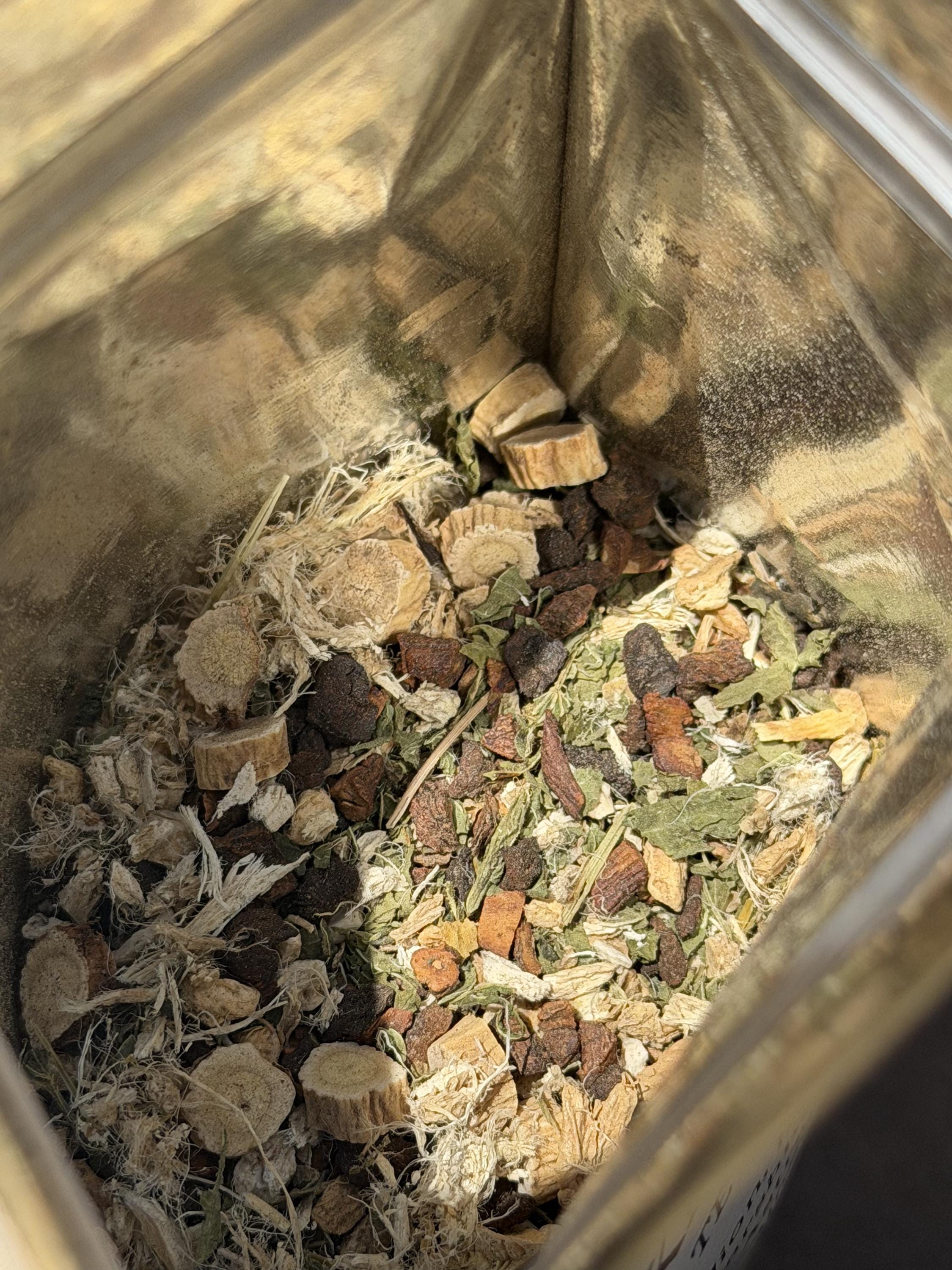 Close-up of the earthy loose herbal blend with roots, nettle and ginger