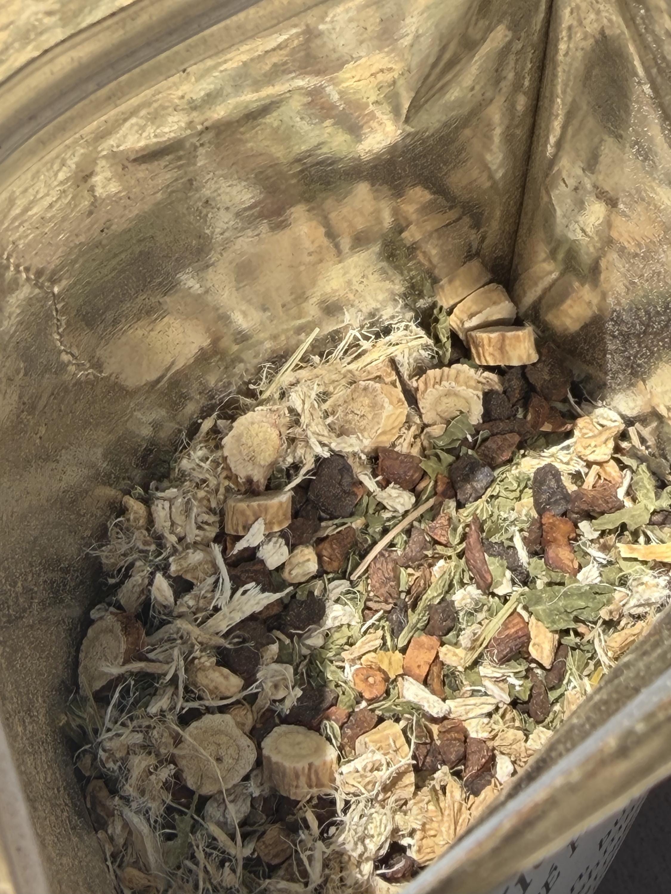 Botanical close-up of Root & Renew loose leaf tea with roasted roots and herbs